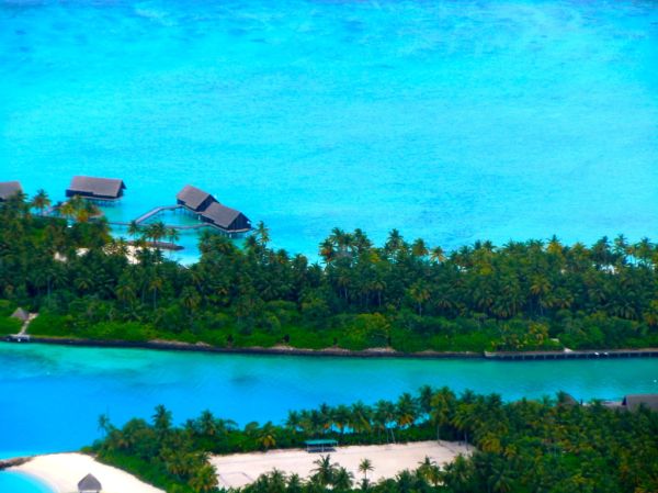 Maldives seaplane over atolls